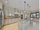 Elegant kitchen boasts updated stainless steel appliances and a large island with pendant lighting at 912 Symphony Beach Ln, Apollo Beach, FL 33572