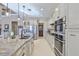 Open kitchen design boasts a central island, stone counters, and stainless steel appliances at 912 Symphony Beach Ln, Apollo Beach, FL 33572
