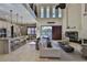 Spacious living room with fireplace, seamless access to kitchen and view of the pool at 912 Symphony Beach Ln, Apollo Beach, FL 33572
