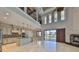 Open-concept living area with kitchen, fireplace, and high ceilings for seamless entertaining at 912 Symphony Beach Ln, Apollo Beach, FL 33572