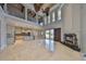 Open concept living room with fireplace, soaring ceilings, and seamless access to the kitchen at 912 Symphony Beach Ln, Apollo Beach, FL 33572