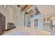 Open-concept living area with high ceilings, fireplace, and travertine flooring at 912 Symphony Beach Ln, Apollo Beach, FL 33572