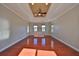 Expansive living room offers plenty of sunlight with wood floors, fan and neutral walls at 912 Symphony Beach Ln, Apollo Beach, FL 33572