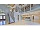 Spacious living area with soaring ceilings, staircase, and seamless flow to kitchen at 912 Symphony Beach Ln, Apollo Beach, FL 33572