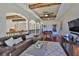 Comfortable living room area with hardwood floors, coffered ceilings, and a pool table at 912 Symphony Beach Ln, Apollo Beach, FL 33572