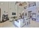Bright and airy living room with soaring ceilings, fireplace, and large windows at 912 Symphony Beach Ln, Apollo Beach, FL 33572