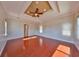 Spacious living room with tray ceiling, ceiling fan and hardwood floors at 912 Symphony Beach Ln, Apollo Beach, FL 33572
