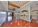Bright loft with hardwood floors, wood-beamed ceilings, and sliding glass doors to the outdoor area at 912 Symphony Beach Ln, Apollo Beach, FL 33572