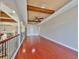 A loft area featuring hardwood floors, a ceiling fan, and arched openings to the lower level at 912 Symphony Beach Ln, Apollo Beach, FL 33572