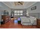 Inviting main bedroom with hardwood floors, grey walls, decorative headboard and matching nightstands at 912 Symphony Beach Ln, Apollo Beach, FL 33572