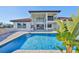 Back of house featuring a pool, barbecue, outdoor seating, and a lush tropical landscape at 912 Symphony Beach Ln, Apollo Beach, FL 33572
