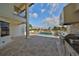 Inviting outdoor space with a pool, barbecue area, and travertine patio at 912 Symphony Beach Ln, Apollo Beach, FL 33572