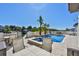 Relaxing outdoor space with a pool, spa, and seating area overlooking the water at 912 Symphony Beach Ln, Apollo Beach, FL 33572