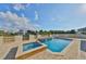 Beautiful backyard pool and jacuzzi with manicured landscaping and waterfront views at 912 Symphony Beach Ln, Apollo Beach, FL 33572