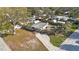 Aerial view of a home with a long driveway and a spacious, fenced backyard at 9169 Robin Rd, Seminole, FL 33777