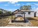 Backyard sandbox area with covering and play toys, and outdoor seating at 9169 Robin Rd, Seminole, FL 33777