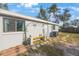 A backyard featuring a bench beneath an arch with space for outdoor enjoyment at 9169 Robin Rd, Seminole, FL 33777