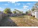 Large backyard with an outdoor dining area, grill, and stepping stone pathway at 9169 Robin Rd, Seminole, FL 33777