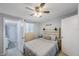 Cozy bedroom with a ceiling fan and ensuite bathroom featuring a walk-in shower at 9169 Robin Rd, Seminole, FL 33777