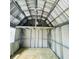 Interior of a shed with wood flooring and metal framing; window to exterior at 9169 Robin Rd, Seminole, FL 33777
