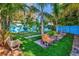 Relaxing backyard featuring turf grass with benches and tropical landscaping at 1011 W Columbus Dr, Tampa, FL 33602