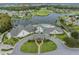 Aerial view of a beautiful clubhouse, pool, and golf course surrounded by a lake and community at 11018 Courtland St, Trinity, FL 34655