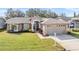 Charming single-story home with manicured lawn and attached two-car garage at 11018 Courtland St, Trinity, FL 34655