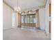 Bright living room featuring a sliding glass door leading to an enclosed lanai at 11018 Courtland St, Trinity, FL 34655