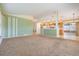 Open floor plan living room with access to the kitchen and lanai at 11018 Courtland St, Trinity, FL 34655