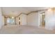 Open-concept living room with access to the kitchen and a view of the screened lanai at 11018 Courtland St, Trinity, FL 34655