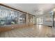 Bright sunroom with tile flooring and many windows offering views of the outdoors at 11018 Courtland St, Trinity, FL 34655