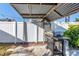 Backyard area featuring a grill under a rustic corrugated steel awning at 12359 82Nd Avenue, Seminole, FL 33772