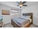 This bedroom features a rustic wooden bedframe, a ceiling fan, and a window with natural light at 12359 82Nd Avenue, Seminole, FL 33772