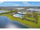 Aerial view of community pool, clubhouse, lakes, and homes in a beautiful residential neighborhood at 1274 Ocean Spray Dr, Ruskin, FL 33570