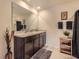 Bathroom featuring double sinks, a granite countertop, dark wood cabinets, and decorative accents at 1274 Ocean Spray Dr, Ruskin, FL 33570