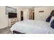 Bedroom featuring a queen bed, soft carpet, a chest of drawers with a TV, and light-filled windows at 1274 Ocean Spray Dr, Ruskin, FL 33570
