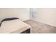 Simple bedroom featuring a twin bed, soft carpet, and a window for natural light at 1274 Ocean Spray Dr, Ruskin, FL 33570