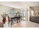 Bright dining area with tile floors features a sliding glass door leading to the backyard and an open concept layout at 1274 Ocean Spray Dr, Ruskin, FL 33570