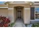 Inviting entryway with neutral colors and tasteful landscaping creates a warm welcome for residents and guests at 1274 Ocean Spray Dr, Ruskin, FL 33570