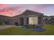 Charming single-story home boasts a well-maintained lawn, neutral-colored facade, and an attached two-car garage at 1274 Ocean Spray Dr, Ruskin, FL 33570