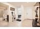 Bright hallway leads to a bathroom and bedroom; features neutral tile floors, white walls, and a view of the front door at 1274 Ocean Spray Dr, Ruskin, FL 33570