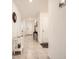 Bright hallway features neutral-colored tile flooring and walls with white trim leading to the front door at 1274 Ocean Spray Dr, Ruskin, FL 33570