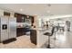 The kitchen boasts stainless appliances, granite countertops, a large island with bar seating, and dark wood cabinets at 1274 Ocean Spray Dr, Ruskin, FL 33570