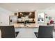 Open concept kitchen with stainless steel appliances, an island with granite countertops, and dark wood cabinets at 1274 Ocean Spray Dr, Ruskin, FL 33570