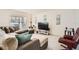 Bright living room featuring neutral walls, tile floors, and a comfortable seating area with a large sectional sofa at 1274 Ocean Spray Dr, Ruskin, FL 33570