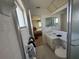 This bathroom features a shower with sliding glass doors, a single sink, and a door to the bedroom at 14132 89Th Ave, Seminole, FL 33776