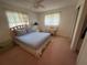 Bedroom with a ceiling fan, a full bed, a desk, and pink carpet at 14132 89Th Ave, Seminole, FL 33776