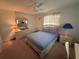 This is a bedroom with a ceiling fan, a full bed, a desk, and pink carpet at 14132 89Th Ave, Seminole, FL 33776