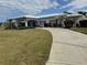 Beautifully landscaped home featuring a spacious driveway, manicured lawn and tropical foliage at 14132 89Th Ave, Seminole, FL 33776