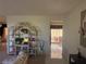 A bright hallway view leading to a lanai, complemented by a decorative shelving unit at 14132 89Th Ave, Seminole, FL 33776